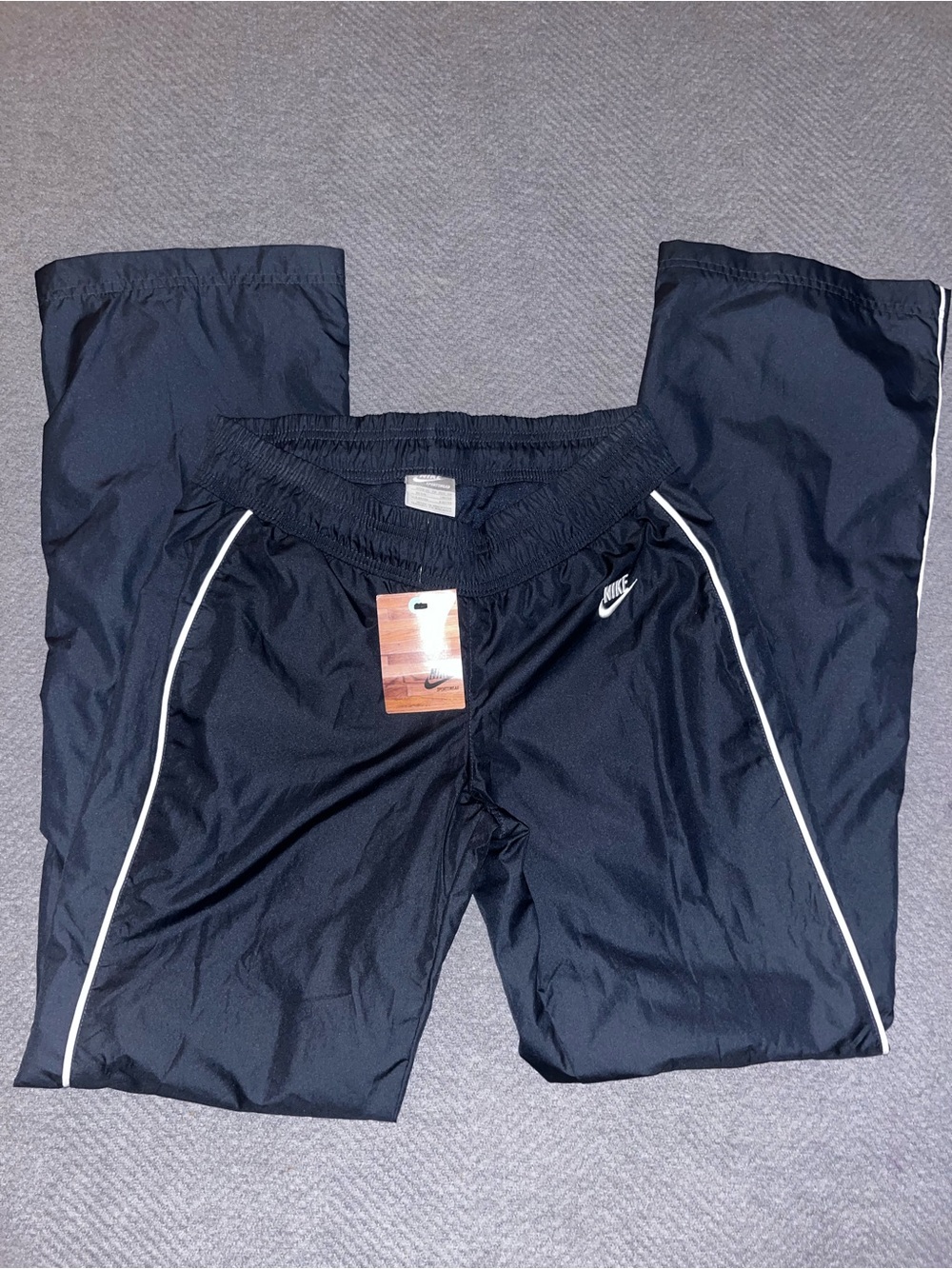 NWT women’s VTG Nike classic black track windbreaker pants. Size XS. 31” inseam.